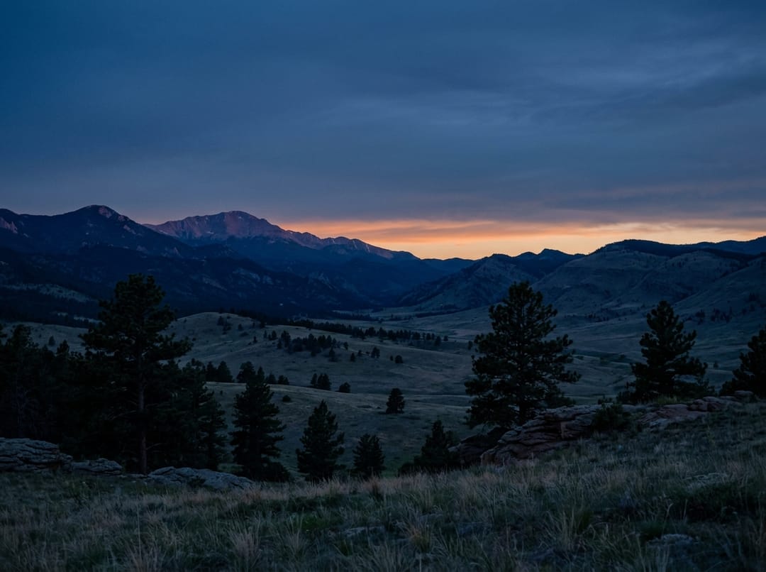 The same range at dusk, the last warm light along the horizon